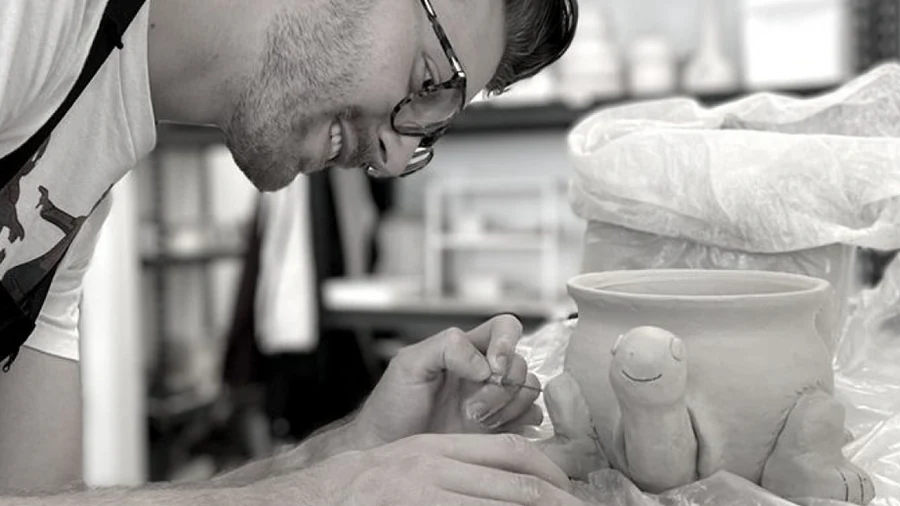 Dan sculpting pottery